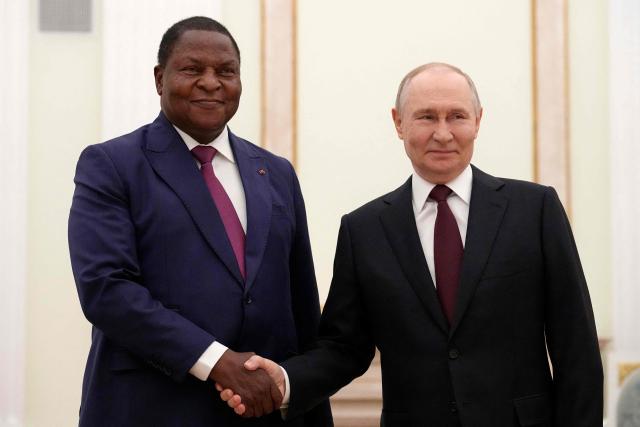 Russian President Vladimir Putin, (R) and Central African Republic President Faustin-Archange Touadera shake hands during their meeting at the Kremlin in Moscow on March 5, 2026. (Photo by Alexander Zemlianichenko / POOL / AFP)