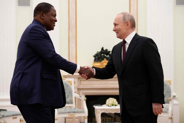 Russian President Vladimir Putin, (R) and Central African Republic President Faustin-Archange Touadera shake hands during their meeting at the Kremlin in Moscow on March 5, 2026. (Photo by Alexander Zemlianichenko / POOL / AFP)