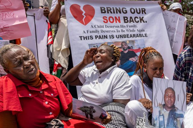 Relatives of Kenyan nationals, that was duped into fighting for the Russian army in Ukraine, react as they stage a sit in outside the parliament buildings during a peaceful demonstration demanding urgent government action to repatriate their kin, in Nairobi on March 5, 2026. More than 1000 Kenyans have gone to fight for the Russian army in Ukraine, most of them tricked into signing military contracts, according to an intelligence report presented to Kenya's parliament. (Photo by SIMON MAINA / AFP)