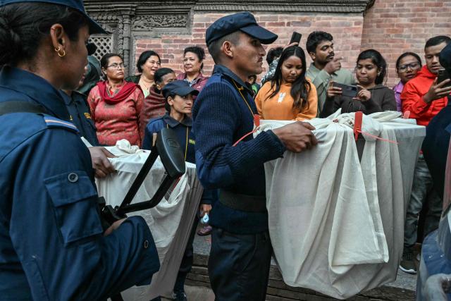 Security personnel and electoral officials carry ballot boxes to the counting centre after voting ends at a polling station during Nepal's general election in Lalitpur on March 5, 2026. Polls closed on March 5 in Nepal's first general election since deadly 2025 anti-corruption protests toppled the government, AFP reporters saw. (Photo by Tauseef MUSTAFA / AFP)