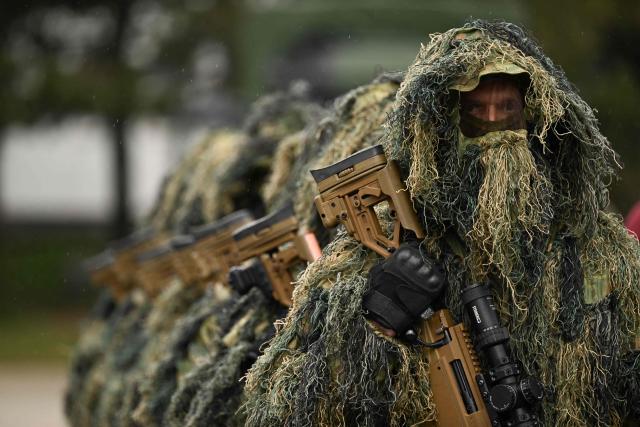 Members of the Kosovo Security Force (KSF) take part in a ceremony marking the 28th anniversary of the killing of Kosovo Liberation Army (KLA) founding member and commander Adem Jashari, in Pristina on March 5, 2026. Jashari, seen as the "father of the KLA", was among 45 members of his family killed by Serb security forces in the village of Prekaz some 50 km west of the Kosovo capital Pristina, sparking a full-blown rebel insurgency. (Photo by Armend NIMANI / AFP)