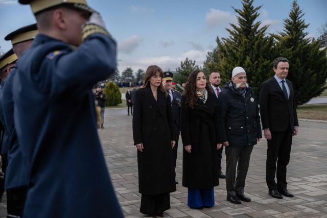 Kosovo's President Vjosa Osmani (2ndL) and Kosovo Prime Minister Albin Kurti (R) take part in a ceremony marking the 28th anniversary of the killing of Kosovo Liberation Army (KLA) founding member and commander Adem Jashari, in Pristina on March 5, 2026. Adem Jashari, seen as the "father of the KLA", was among 45 members of his family killed by Serb security forces in the village of Prekaz some 50 km west of the Kosovo capital Pristina, sparking a full-blown rebel insurgency. (Photo by Armend NIMANI / AFP)