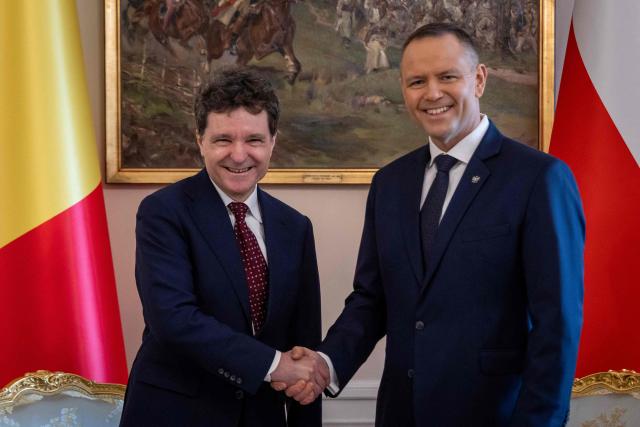 Poland's President Karol Nawrocki (R) and Romania's President Nicusor Dan (L) shake hands during their meeting at the Presidential Palace in Warsaw on March 5, 2026. (Photo by Wojtek RADWANSKI / AFP)