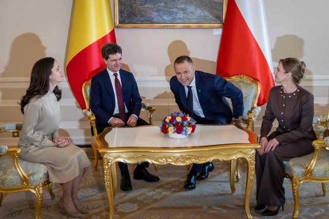 Poland's President Karol Nawrocki (2R), his wife Marta Nawrocka (R), Romania's President Nicusor Dan (2L) and his partner Mirabela Gradinaru (L) attend a meeting at the Presidential Palace in Warsaw on March 5, 2026. (Photo by Wojtek RADWANSKI / AFP)