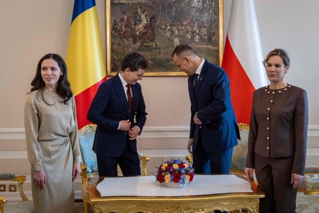 Poland's President Karol Nawrocki (2R), his wife Marta Nawrocka (R), Romania's President Nicusor Dan (2L) and his partner Mirabela Gradinaru (L) attend a meeting at the Presidential Palace in Warsaw on March 5, 2026. (Photo by Wojtek RADWANSKI / AFP)