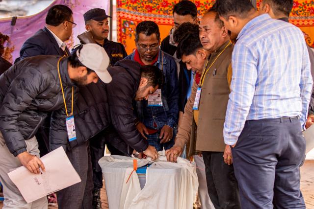 Electoral officials seal a ballot box as voting ends at a polling station during Nepal's general election in Kathmandu on March 5, 2026. Nepal voted on March 5 for a new parliament in a high-stakes showdown between an entrenched old guard and a powerful youth movement, six months after deadly anti-corruption protests toppled the government. (Photo by Prabin RANABHAT / AFP)