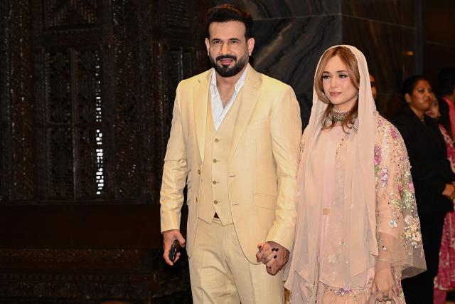 Former Indian cricket player Irfan Pathan (L) and his wife Safa Baig pose for photographs during the wedding ceremony of Arjun Tendulkar, son of former Indian cricketer Sachin Tendulkar, in Mumbai on March 5, 2026. (Photo by Sujit JAISWAL / AFP)