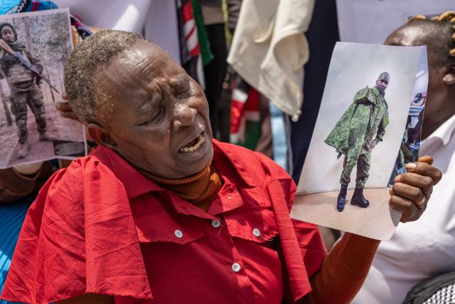 A relative of a Kenyan national, that was duped into fighting for the Russian army in Ukraine, reacts as they stage a sit in outside the parliament buildings during a peaceful demonstration demanding urgent government action to repatriate their kin, in Nairobi on March 5, 2026. More than 1000 Kenyans have gone to fight for the Russian army in Ukraine, most of them tricked into signing military contracts, according to an intelligence report presented to Kenya's parliament. (Photo by SIMON MAINA / AFP)