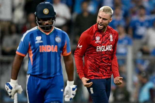 England's Will Jacks (R) celebrates after taking the wicket of India's Abhishek Sharma during the 2026 ICC Men's T20 Cricket World Cup semi-final match between India and England at the Wankhede Stadium in Mumbai on March 5, 2026. (Photo by Indranil MUKHERJEE / AFP)