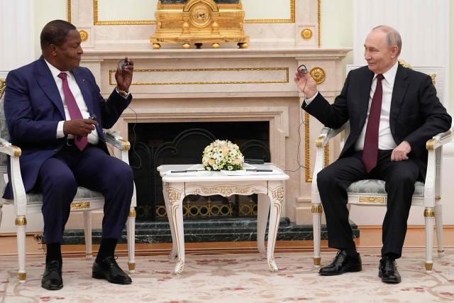 Russian President Vladimir Putin (R) greets Central African Republic President Faustin Archange Touadera at the Kremlin in Moscow on March 5, 2026. (Photo by Alexander Zemlianichenko / POOL / AFP)
