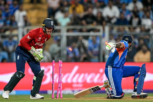 England's wicketkeeper Jos Buttler (L) stumps out India's captain Suryakumar Yadav during the 2026 ICC Men's T20 Cricket World Cup semi-final match between India and England at the Wankhede Stadium in Mumbai on March 5, 2026. (Photo by Punit PARANJPE / AFP)
