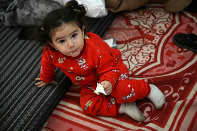 A girl sits inside a school transformed into a shelter for displaced people in the town of Dekwaneh north of Beirut on March 5, 2026. Israel bombarded Lebanon on March 2, expanding the conflict across the region after the massive Israel-US attack on Iran that the US president launched to topple Tehran's ruling clerics, and killing their supreme leader on February 28. (Photo by Joseph EID / AFP)