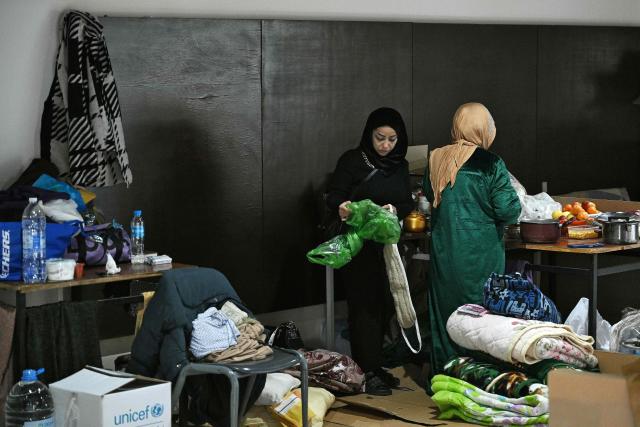 Women prepare food at a school transformed into a shelter for displaced people in the town of Dekwaneh north of Beirut on March 5, 2026. Israel bombarded Lebanon on March 2, expanding the conflict across the region after the massive Israel-US attack on Iran that the US president launched to topple Tehran's ruling clerics, and killing their supreme leader on February 28. (Photo by Joseph EID / AFP)