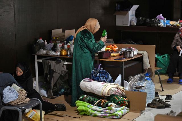 Women prepare food at a school transformed into a shelter for displaced people in the town of Dekwaneh north of Beirut on March 5, 2026. Israel bombarded Lebanon on March 2, expanding the conflict across the region after the massive Israel-US attack on Iran that the US president launched to topple Tehran's ruling clerics, and killing their supreme leader on February 28. (Photo by Joseph EID / AFP)