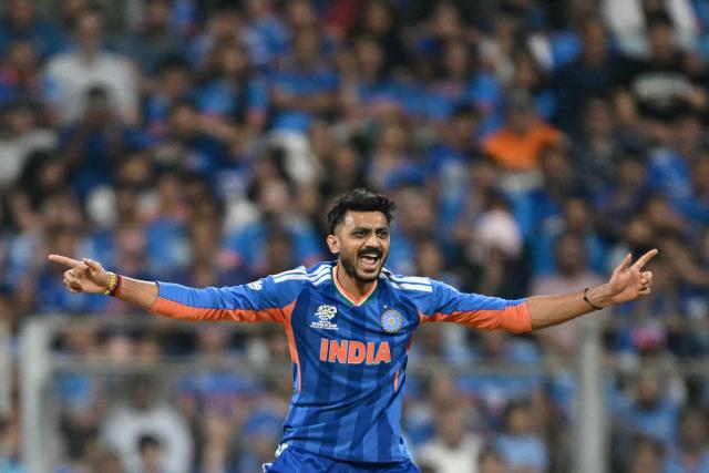 India's Axar Patel celebrates after taking the wicket of England's Tom Banton during the 2026 ICC Men's T20 Cricket World Cup semi-final match between India and England at the Wankhede Stadium in Mumbai on March 5, 2026. (Photo by Indranil MUKHERJEE / AFP)