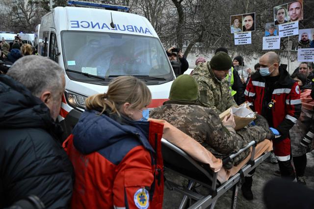 Medics transport a freed Ukrainian POW on a stretcher upon his arrival after a prisoner exchange in the Chernygiv region on March 5, 2026, amid the Russian invasion of Ukraine. Ukraine and Russia each freed 200 prisoners of war, the first part of an exchange that will see them swap 500 people each in total, officials said. (Photo by Genya SAVILOV / AFP)
