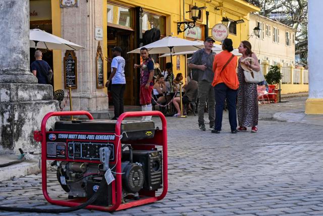 A shopkeeper uses a power generator after a blackout in Havana on March 5, 2026. Cuban authorities said on March 5, 2026 that electricity is slowly coming back to end a blackout that hit two-thirds of the beleaguered communist nation and stemmed from a lack of fuel under US pressure. (Photo by YAMIL LAGE / AFP)
