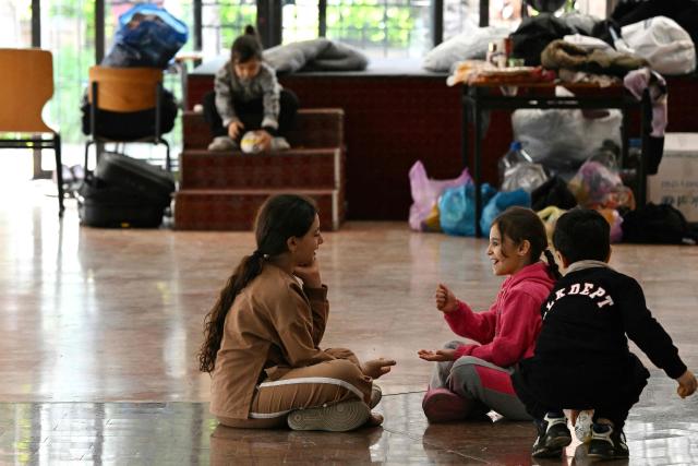 Children chat inside a school transformed into a shelter for displaced people in the town to Dekwaneh, north of Beirut on March 5, 2026. Israel bombarded Lebanon on March 2, expanding the conflict across the region after the massive Israel-US attack on Iran that the US president launched to topple Tehran's ruling clerics, and killing their supreme leader on February 28. (Photo by Joseph EID / AFP)