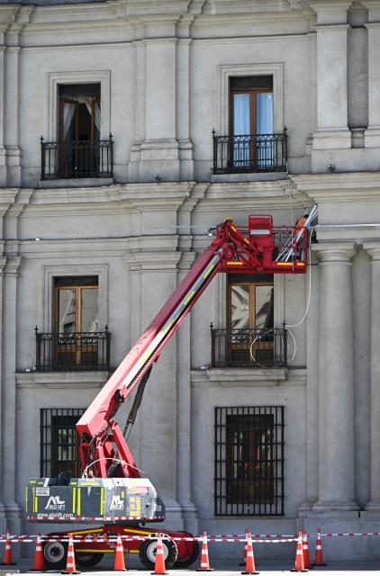 Workers prepare La Moneda Palace ahead of the arrival of the new President Jose Antonio Kast, in Santiago on March 5, 2026. Chile's presidential palace La Moneda is being prepared to serve as a residence again after nearly 70 years, with president-elect Jose Antonio Kast scheduled to move in on March 11. Kast will be the first head of state to live in the neoclassical Santiago landmark since 1958. (Photo by Rodrigo ARANGUA / AFP)