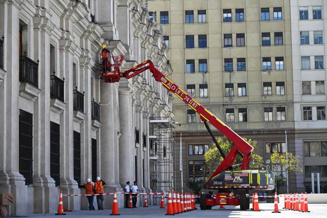 Workers prepare La Moneda Palace ahead of the arrival of the new President Jose Antonio Kast, in Santiago on March 5, 2026. Chile's presidential palace La Moneda is being prepared to serve as a residence again after nearly 70 years, with president-elect Jose Antonio Kast scheduled to move in on March 11. Kast will be the first head of state to live in the neoclassical Santiago landmark since 1958. (Photo by Rodrigo ARANGUA / AFP)