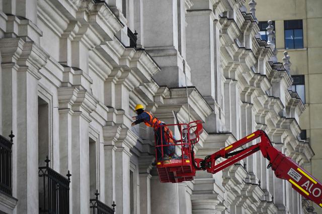 Workers prepare La Moneda Palace ahead of the arrival of the new President Jose Antonio Kast, in Santiago on March 5, 2026. Chile's presidential palace La Moneda is being prepared to serve as a residence again after nearly 70 years, with president-elect Jose Antonio Kast scheduled to move in on March 11. Kast will be the first head of state to live in the neoclassical Santiago landmark since 1958. (Photo by Rodrigo ARANGUA / AFP)