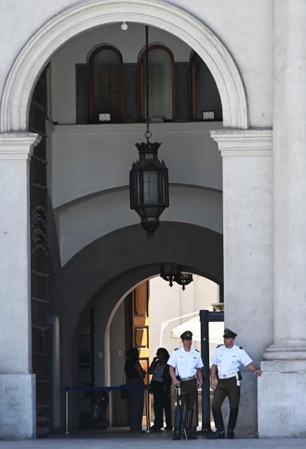 Members of the Presidential Guard stand on the entrance of La Moneda Palace ahead of the arrival of the new President Jose Antonio Kast, in Santiago on March 5, 2026. Chile's presidential palace La Moneda is being prepared to serve as a residence again after nearly 70 years, with president-elect Jose Antonio Kast scheduled to move in on March 11. Kast will be the first head of state to live in the neoclassical Santiago landmark since 1958. (Photo by Rodrigo ARANGUA / AFP)