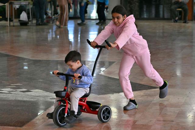 Children play inside a school transformed into a shelter for displaced people in the town to Dekwaneh, north of Beirut on March 5, 2026. Israel bombarded Lebanon on March 2, expanding the conflict across the region after the massive Israel-US attack on Iran that the US president launched to topple Tehran's ruling clerics, and killing their supreme leader on February 28. (Photo by Joseph EID / AFP)
