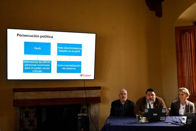 Director of research of the NGO Cristosal, Rene Valiente (C), speaks as Legal Director Abraham Abrego (L) and Karin Eder, Director of the Regional Office in Central America and Mexico at Awo International, listen during the presentation of the report “The Price of Dissent: Criminalization, Political Persecution in El Salvador (2019–2025)”, in Guatemala City on March 5, 2026. (Photo by JOHAN ORDONEZ / AFP)