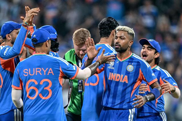 India's players celebrate after their team's win in the 2026 ICC Men's T20 Cricket World Cup semi-final match against England at the Wankhede Stadium in Mumbai on March 5, 2026. (Photo by Punit PARANJPE / AFP)