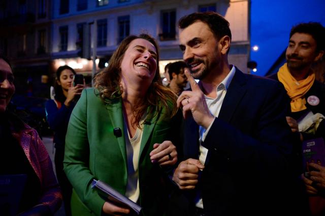 Mayor of Lyon and candidate for re-election in France's upcoming local elections Gregory Doucet (R) and the National secretary of the left-wing party The Ecologistes Marine Tondelier arrive to distribute campaign leaflets in Lyon, central eastern France on March 5, 2026. (Photo by Olivier CHASSIGNOLE / AFP)
