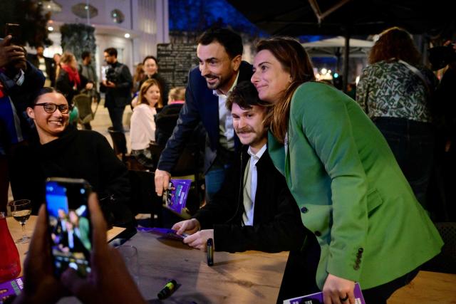 Mayor of Lyon and candidate for re-election in France's upcoming local elections Gregory Doucet (R) and the National secretary of the left-wing party The Ecologistes Marine Tondelier pose for pictures as they distribute campaign leaflets in Lyon, central eastern France on March 5, 2026. (Photo by Olivier CHASSIGNOLE / AFP)