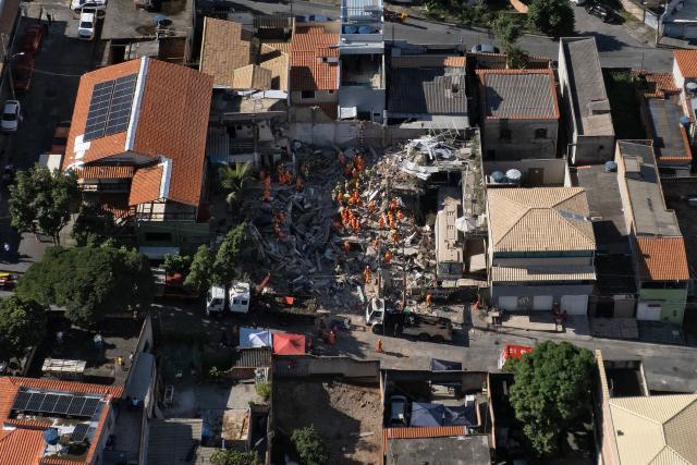 Aerial view of Minas Gerais' firefighters working at a collapsed nursing home in Belo Horizonte, Minas Gerais State, Brazil on March 5, 2026. The collapse of a nursing home in the city of Belo Horizonte, in south-eastern Brazil, left at least four people dead while firefighters continue to search the rubble for eight missing persons, according to the latest reports. (Photo by Douglas MAGNO / AFP)