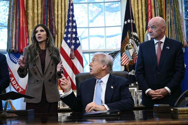 (FILES) US President Donald Trump (C) and FIFA president Gianni Infantino (R) listens to the US Secretary of Homeland Security Kristi Noem during a meeting with the White House Task Force on the FIFA World Cup 2026 in the Oval Office of the White House in Washington, DC on November 17, 2025. US President Donald Trump announced on March 5, 2026, that he was replacing Kristi Noem, head of the powerful Department of Homeland Security. Trump, in a post on Truth Social, said Oklahoma Senator Markwayne Mullen would take over from Noem at DHS on March 31. (Photo by Brendan SMIALOWSKI / AFP)