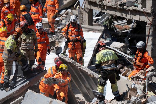 Minas Gerais' firefighters work at a collapsed nursing home in Belo Horizonte, Minas Gerais State, Brazil on March 5, 2026. A collapse at a nursing home in the southeastern Brazilian city of Belo Horizonte left at least two people dead on March 5, 2026, while firefighters worked to rescue 10 other victims from the rubble. (Photo by DOUGLAS MAGNO / AFP)