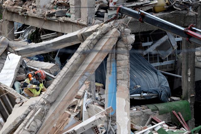 A Minas Gerais' firefighter works at a collapsed nursing home in Belo Horizonte, Minas Gerais State, Brazil on March 5, 2026. A collapse at a nursing home in the southeastern Brazilian city of Belo Horizonte left at least two people dead on March 5, 2026, while firefighters worked to rescue 10 other victims from the rubble. (Photo by DOUGLAS MAGNO / AFP)
