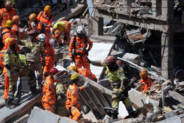 Minas Gerais' firefighters work at a collapsed nursing home in Belo Horizonte, Minas Gerais State, Brazil on March 5, 2026. A collapse at a nursing home in the southeastern Brazilian city of Belo Horizonte left at least two people dead on March 5, 2026, while firefighters worked to rescue 10 other victims from the rubble. (Photo by DOUGLAS MAGNO / AFP)