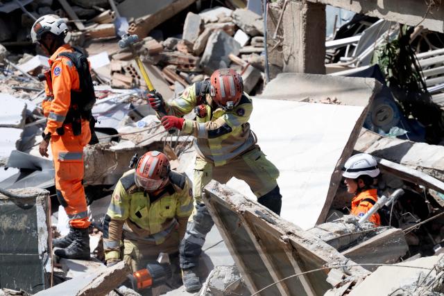 Minas Gerais' firefighters work at a collapsed nursing home in Belo Horizonte, Minas Gerais State, Brazil on March 5, 2026. A collapse at a nursing home in the southeastern Brazilian city of Belo Horizonte left at least two people dead on March 5, 2026, while firefighters worked to rescue 10 other victims from the rubble. (Photo by DOUGLAS MAGNO / AFP)