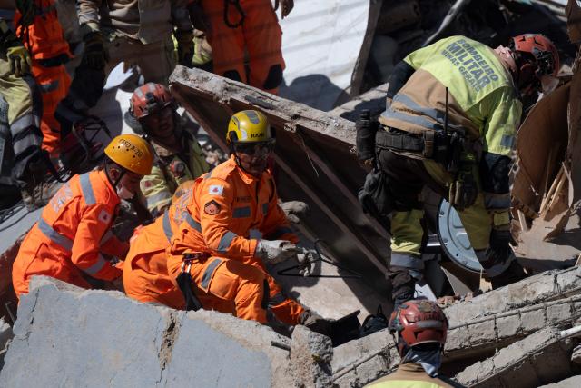 Minas Gerais' firefighters work at a collapsed nursing home in Belo Horizonte, Minas Gerais State, Brazil on March 5, 2026. A collapse at a nursing home in the southeastern Brazilian city of Belo Horizonte left at least two people dead on March 5, 2026, while firefighters worked to rescue 10 other victims from the rubble. (Photo by DOUGLAS MAGNO / AFP)