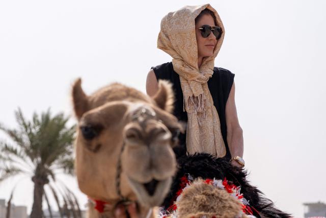 (FILES) US Homeland Security Secretary Kristi Noem rides a camel before touring Qal'at al-Bahrain Fort near Manama on May 25, 2025. US President Donald Trump on March 5, 2026 fired Kristi Noem as head of the Department of Homeland Security, the agency responsible for carrying out his sweeping immigration crackdown. According to multiple media reports, Trump was upset with Noem's testimony at a Senate hearing this week where she said the president had approved a $220 million DHS advertising campaign in which she featured prominently. (Photo by Alex Brandon / POOL / AFP)