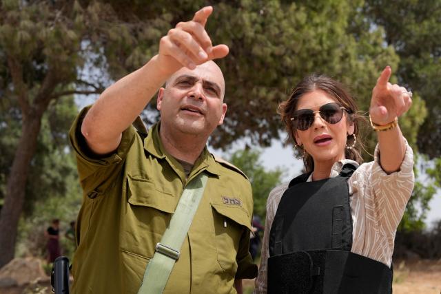 (FILES) An Israeli army officer points as US Homeland Security Secretary Kristi Noem looks toward the Gaza Strip while visiting the Black Arrow memorial site in the Kibbutz Mefalsim on the border with the besieged territory on May 26, 2025. US President Donald Trump on March 5, 2026 fired Kristi Noem as head of the Department of Homeland Security, the agency responsible for carrying out his sweeping immigration crackdown. According to multiple media reports, Trump was upset with Noem's testimony at a Senate hearing this week where she said the president had approved a $220 million DHS advertising campaign in which she featured prominently. (Photo by Alex Brandon / POOL / AFP)