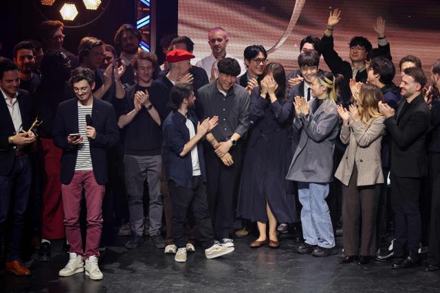 Members of French video game development studio Sandfall Interactive stand on stage as they accept the Best Video Game award for "Clair Obscur: Expedition 33" by French video game development studio Sandfall Interactive during the 7th edition of the Pegases video game awards ceremony at La Cigale in Paris on March 5, 2026. (Photo by Dimitar DILKOFF / AFP)