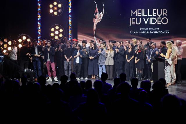 Members of French video game development studio Sandfall Interactive stand on stage as they accept the Best Video Game award for "Clair Obscur: Expedition 33" by French video game development studio Sandfall Interactive during the 7th edition of the Pegases video game awards ceremony at La Cigale in Paris on March 5, 2026. (Photo by Dimitar DILKOFF / AFP)