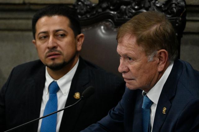Guatemala's Congress president Luis Contreras (R) speaks with deputy Nery Ramos during a Congress session for the election of two magistrates for the Constitutional Court, in Guatemala City on March 5, 2026. (Photo by JOHAN ORDONEZ / AFP)