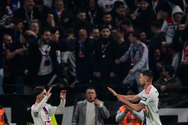 Lyon's Ukrainian forward #77 Roman Yaremchuk (R) celebrates after scoring his team's first goal during the French Cup quarter-final football match between Olympique Lyonnais (OL) and RC Lens at the Groupama Stadium in Decines-Charpieu, central-eastern France, on March 5, 2026. (Photo by OLIVIER CHASSIGNOLE / AFP)