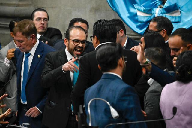 Guatemala's Congress second president Elmer Palencia (2nd L) argues with deputy David Illescas (C) next to Congress president Luis Contreras (L) during a Congress session for the election of two magistrates for the Constitutional Court in Guatemala City on March 5, 2026. (Photo by JOHAN ORDONEZ / AFP)