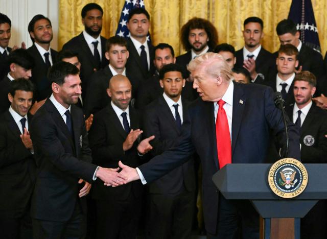 US President Donald Trump shakes hand with Argentinian star Lionel Messi during an event for Inter Miami CF, winners of the 2025 Major League Soccer Cup, in the East Room of the White House in Washington, DC, on March 5, 2026. (Photo by ANDREW CABALLERO-REYNOLDS / AFP)