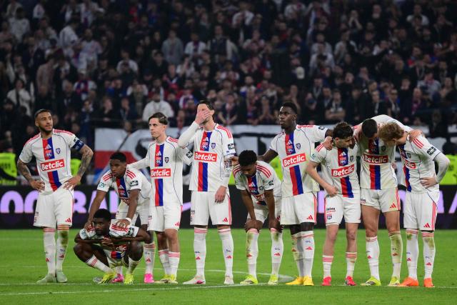Lyon's players react during a penalty shoot-out during the French Cup quarter-final football match between Olympique Lyonnais (OL) and RC Lens at the Groupama Stadium in Decines-Charpieu, central-eastern France, on March 5, 2026. (Photo by Olivier CHASSIGNOLE / AFP)
