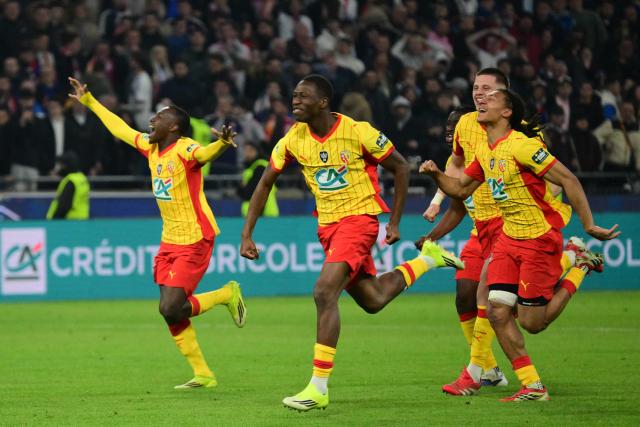 Lens' players celebrate after scoring the winning shot in a penalty shoot-out during the French Cup quarter-final football match between Olympique Lyonnais (OL) and RC Lens at the Groupama Stadium in Decines-Charpieu, central-eastern France, on March 5, 2026. An Israeli strike targeted the southern suburbs of Beirut late on March 5, according to Lebanese state media, following an Israeli evacuation warning. (Photo by Olivier CHASSIGNOLE / AFP)
