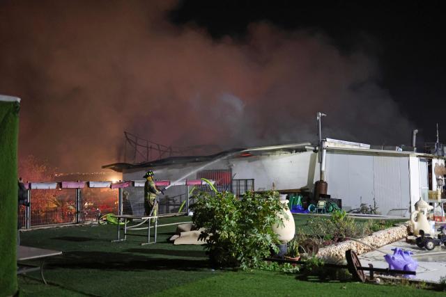 Firefighters work to stop a fire caused by debris after a rocket interception in a residential area near Tel Aviv, on March 5, 2026. The latest round of Iranian missile fire caused explosions across the city and damage in central Israel, but there were no reported casualties and residents have been cleared to leave shelters. Israeli police said it was "currently handling scenes involving fallen projectiles in central Israel," adding that "damage has been caused," but also reporting no injuries.on March 5, 2026. (Photo by AHMAD GHARABLI / AFP)