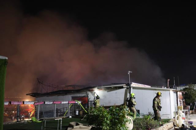 Firefighters work to stop a fire caused by debris after a rocket interception in a residential area near Tel Aviv, on March 5, 2026. The latest round of Iranian missile fire caused explosions across the city and damage in central Israel, but there were no reported casualties and residents have been cleared to leave shelters. Israeli police said it was "currently handling scenes involving fallen projectiles in central Israel," adding that "damage has been caused," but also reporting no injuries.on March 5, 2026. (Photo by AHMAD GHARABLI / AFP)